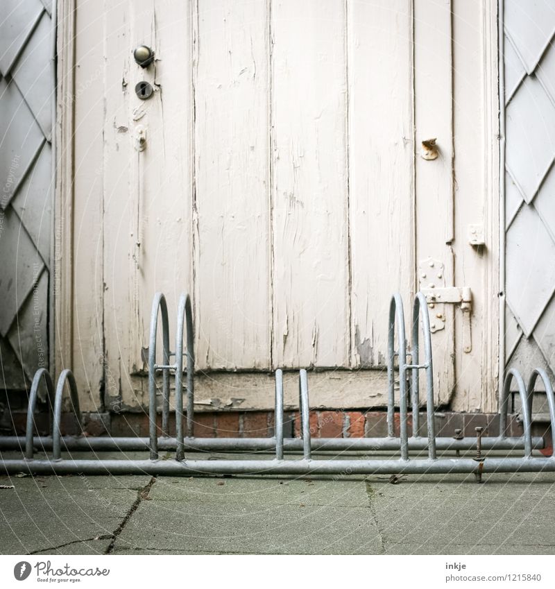 Missing place Lifestyle Deserted Hut Facade Door Bicycle rack Wooden door Metal Old Exceptional Block Poised to act Stupid Misplaced Closed Colour photo