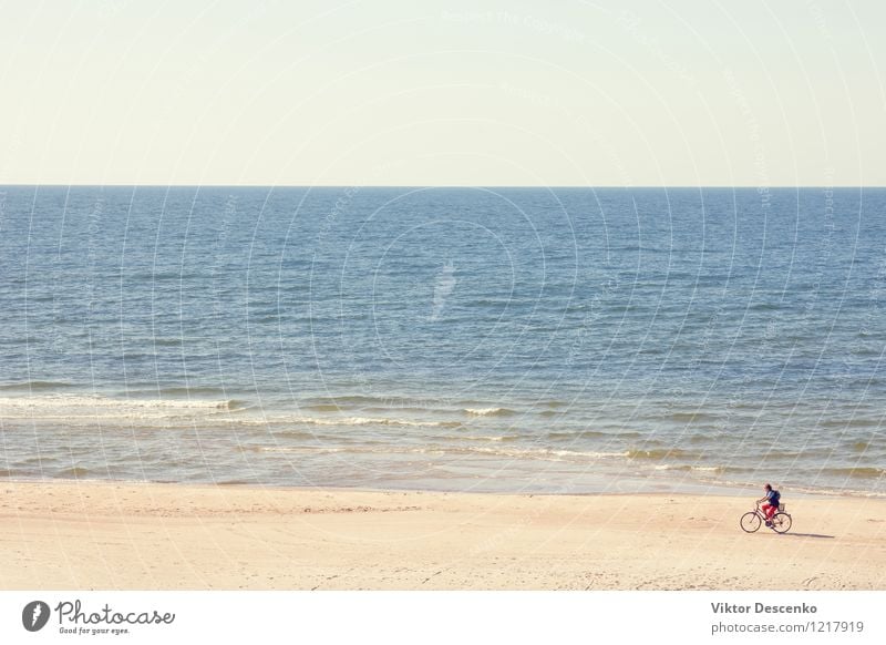 Cyclist rides along the beach Baltic sea Lifestyle Vacation & Travel Summer Beach Ocean Mountain Sports Cycling Man Adults Nature Sky Clouds Fitness Speed