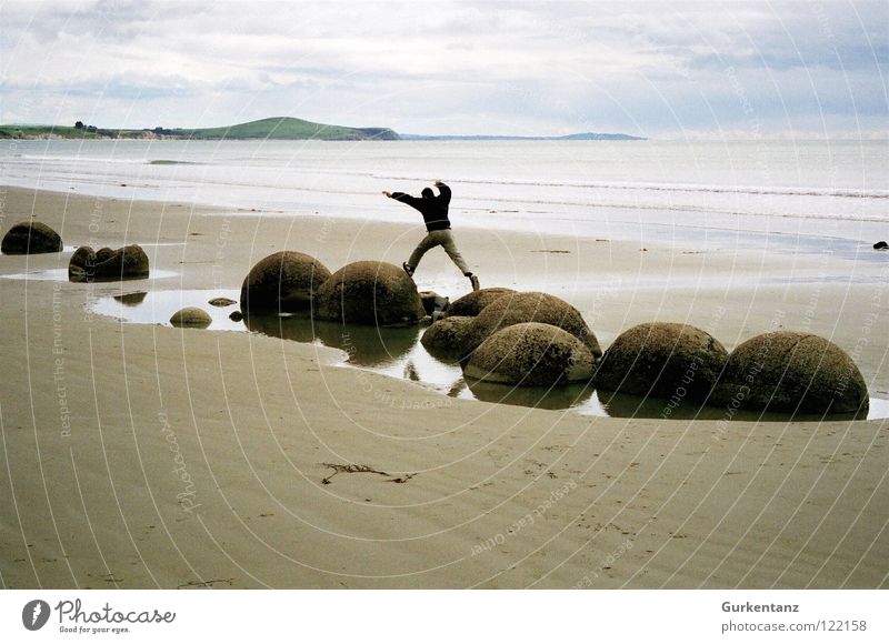rock jumping New Zealand Moeraki Moeraki Boulder Beach South Island Man Jump Autumn Coast Ocean Balance Stone Minerals Sand Ball monolithic