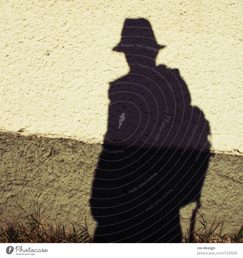 He's got a shadow. Cap Posture To go for a walk Commuter Air Breathe Man Masculine Minimalistic Where Territory Photo shoot Media Photographer Take a photo