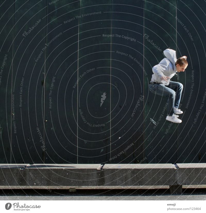 JUMP again Man Wall (building) Going Jump Hop Barrier Turquoise Human being Lucerne Green Background picture Youth (Young adults) Joy Playing go up young