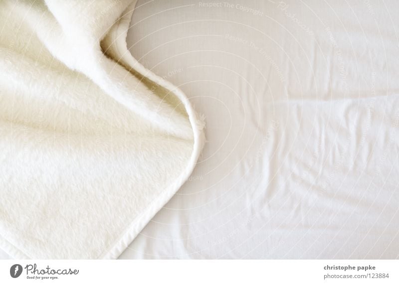 white fleece blanket lies on sheet on bed Duvet Bed Blanket Folds Fleece Detail Structures and shapes Deserted Copy Space left Copy Space right Copy Space top