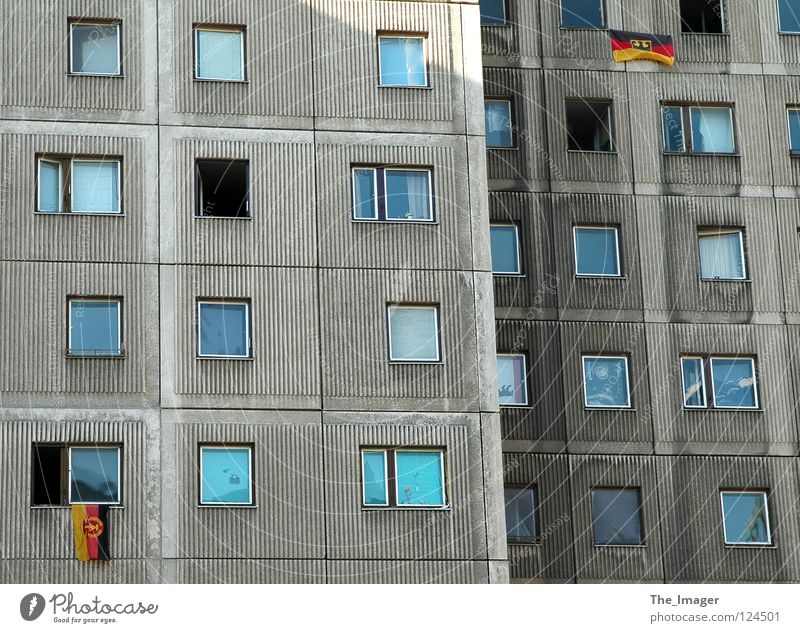 What is it now? Flag Nostalgia Reunification Coat of arms German Flag Prefab construction East Germany Gray Flat (apartment) Window