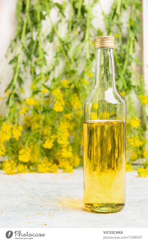 Glass bottle with rapeseed oil Food Cooking oil Nutrition Organic produce Vegetarian diet Diet Bottle Style Design Healthy Eating Life Summer Nature Plant Leaf