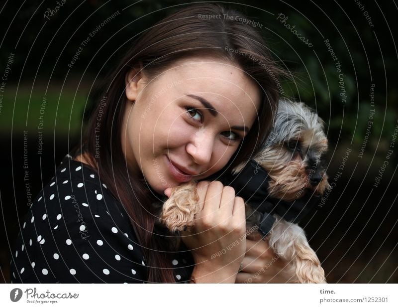 smiling woman with dog on her arm Feminine 1 Human being Park Dress Brunette Long-haired Animal Dog To hold on Smiling Looking pretty Happy Contentment Passion