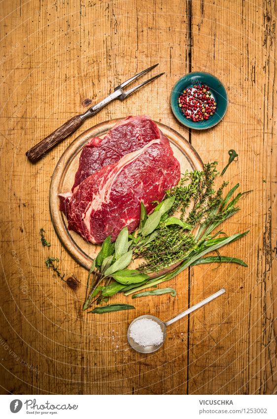 Beef steak with herbs on a rustic wooden table Food Meat Herbs and spices Nutrition Dinner Organic produce Diet Bowl Fork Spoon Style Design Vintage beef steak