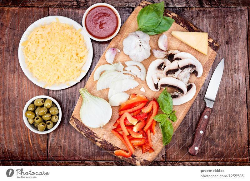 Fresh ingredients for homemade pizza Food Cheese Vegetable Dinner Fast food Bowl Knives Table Leaf Basil board cuisine Garlic Grating grated Home Home-made