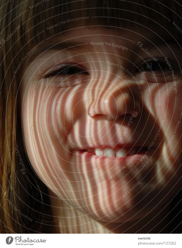EAN II.III.I.IIII.II Child Close-up Portrait photograph Light Shaft of light Drape Dark Earnest Denote Stripe Barcode Science & Research Face Eyes Mouth Nose