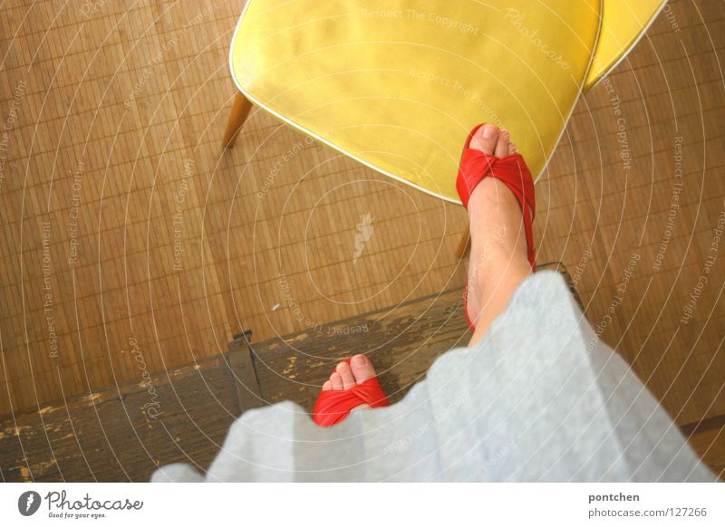 Woman in red open shoes climbs on yellow chair Footwear Summer Sandal Stand wood Chest Ascending Far-off places Conquer Yellow Playing Children's game Room Red