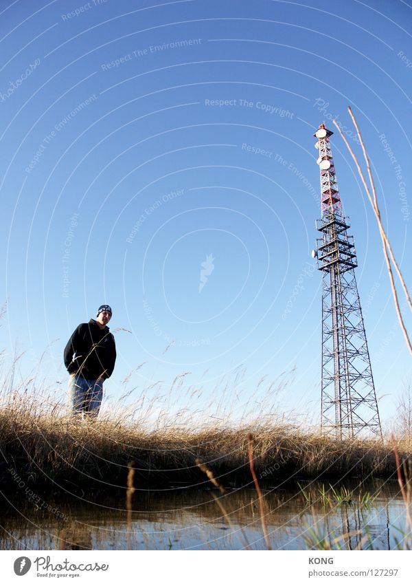three colours big Large Long Radio technology Antenna Worm's-eye view Loneliness Man Gentleman Sky blue Blue Badlands Meadow Blade of grass Steep Pampa Industry