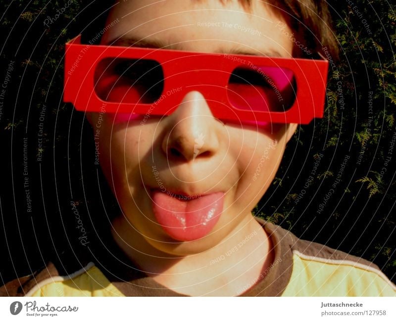The picture of the picture in the picture Boy (child) Child Portrait photograph Eyeglasses Sunglasses Pink Red Happiness Joy Cool (slang) Brash Poster Grimace