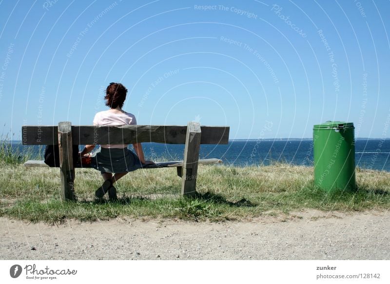 farsightedness Woman Wood Trash container Green Ocean Far-off places Grass Loneliness Break Exterior shot Concentrate Beach Coast Back Bench Water Sky