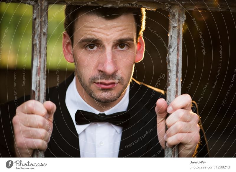 sad man in a suit behind bars Man Captured lattice bars penned Suit locked Human being interdiction