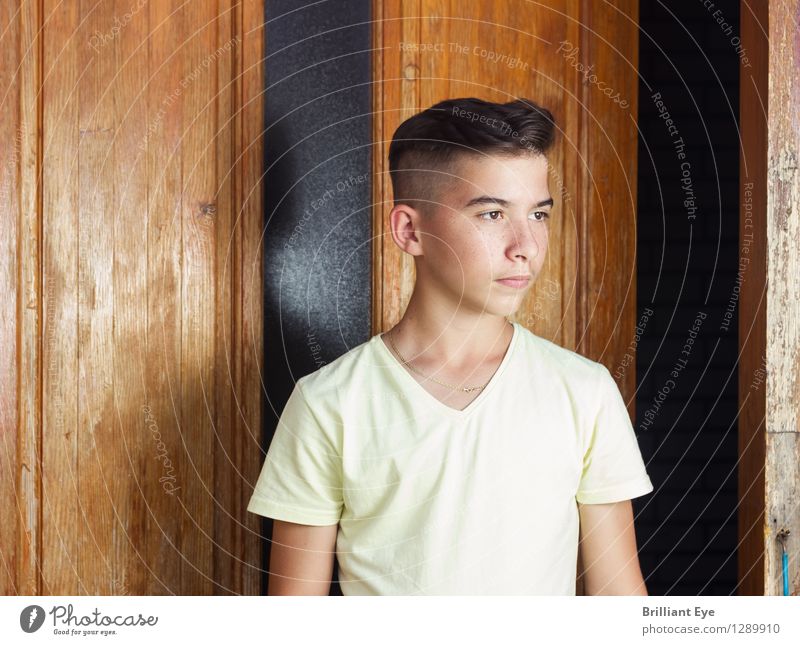 Serious boy in front of a wooden door Style Human being Masculine Boy (child) 1 13 - 18 years Child Youth (Young adults) Nature Fashion Esthetic Cool (slang)