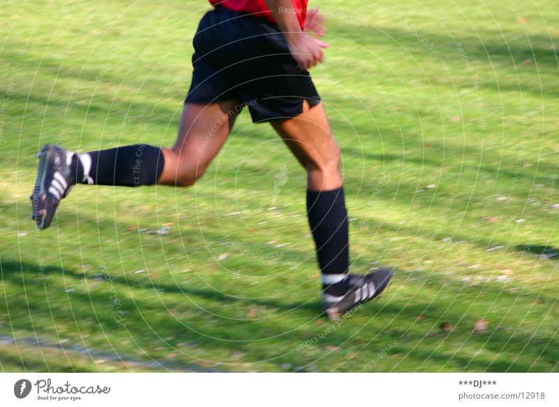 Run if you can! Man Football boots Shorts Abbreviate Grass Lose Playing Sports Human being Legs Feet Walking Soccer Beautiful weather