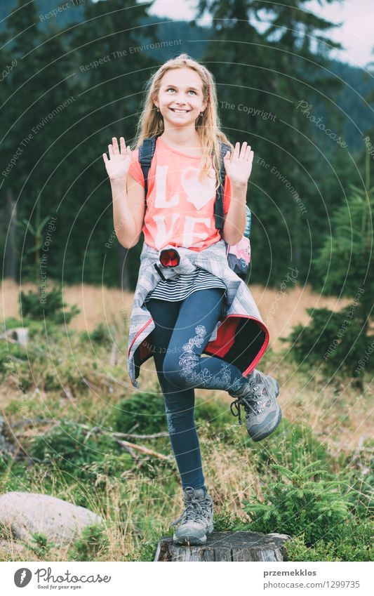 Playful girl posing on a tree trunk Summer Summer vacation Child Girl 8 - 13 years Infancy Nature Smiling Posture Colour photo Exterior shot Day