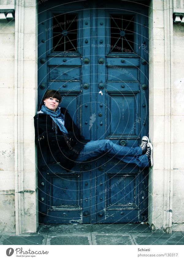 Relaxation deluxe Joy Contentment Woman Adults Gate Door Jeans Stone Sit Blue Paris France Easygoing Chucks Colour photo