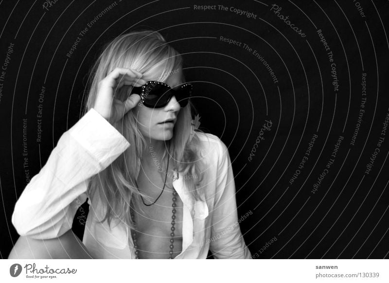 pessimistic Woman Blonde Long-haired Knee Joint Hand Low neckline Chin Background picture Dark Portrait photograph Sunglasses Easygoing Black & white photo