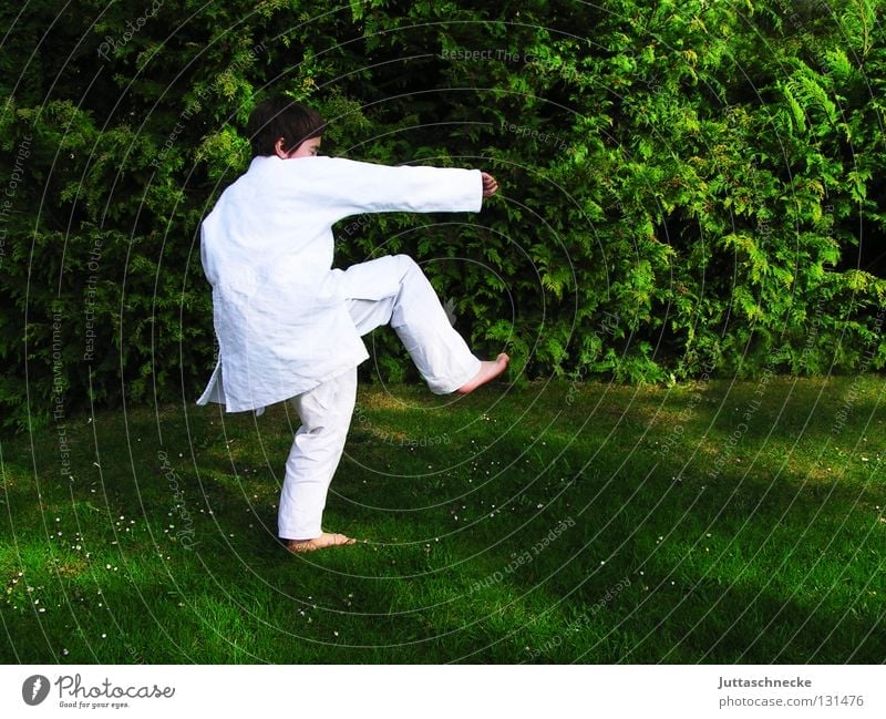 Karate Kid Judo Martial arts White Green Child Boy (child) Practice Kick Jump Combat dress Footstep Tread Japan Samurai Contentment Beat Sporting event