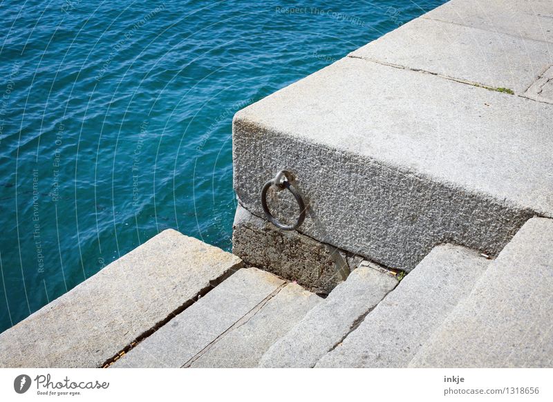 Neptune's door knocker Water Ocean Port City Deserted Harbour Wall (barrier) Wall (building) Stairs Navigation Jetty Stone Circle Level Simple Blue Colour photo