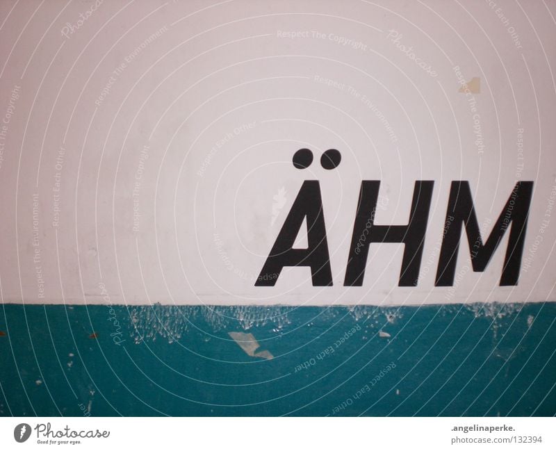 a wall on which the word "ÄHM" is written in large black letters Wall (building) Old White Dirty Rustic Black Large Word Short Think Interior shot Snapshot