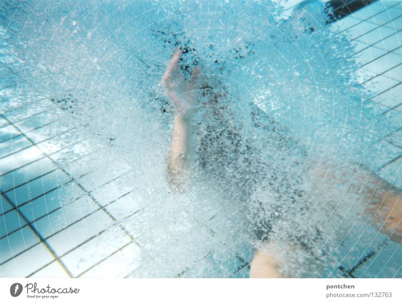 Underwater shot in the swimming pool in the outdoor pool. Man creates air bubbles by movements in the water. Swimming Underwater photo Joy Relaxation Playing