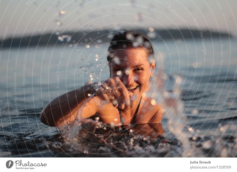 Woman standing in the sea splashing with water in the evening light Summer vacation Ocean Swimming & Bathing Feminine Adults 1 Human being 30 - 45 years