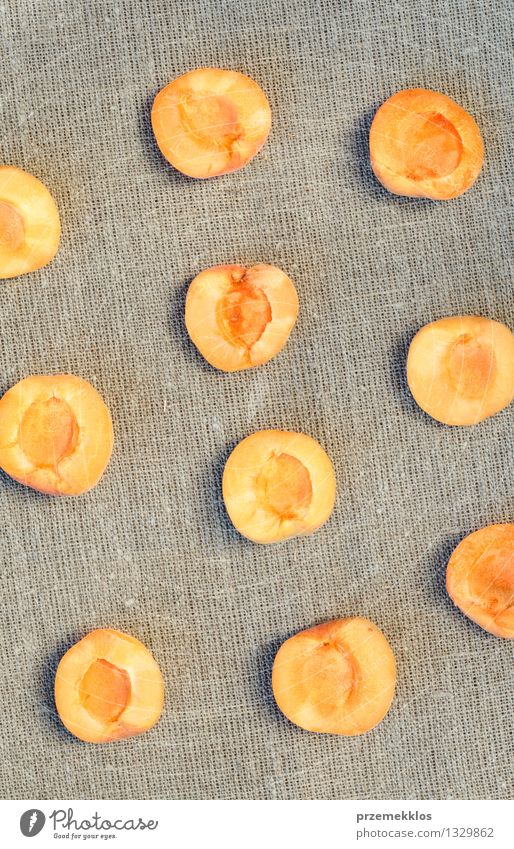Sliced apricots on a linen Food Fruit Organic produce Summer Nature Fresh Delicious Orange Apricot healthy pit Raw ripe Rustic Seasons sweet Vertical