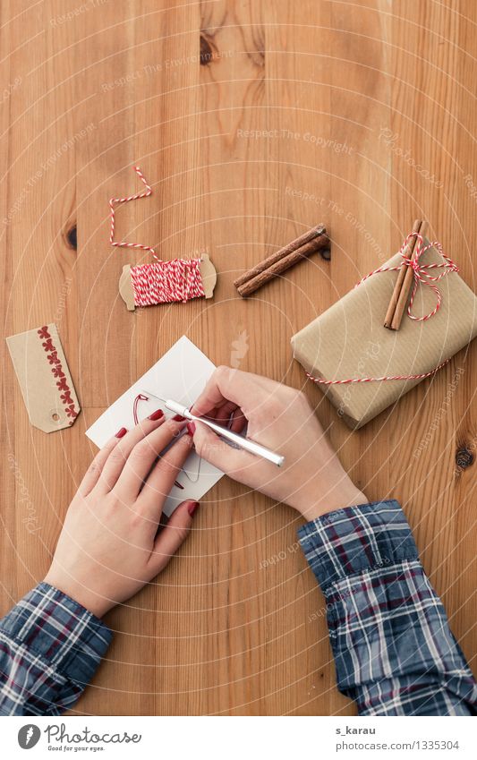 Christmas preparations Christmas & Advent Cutter Knife Feminine Arm Hand 1 Human being Clothing Stationery Paper Packaging Brown Contentment Anticipation