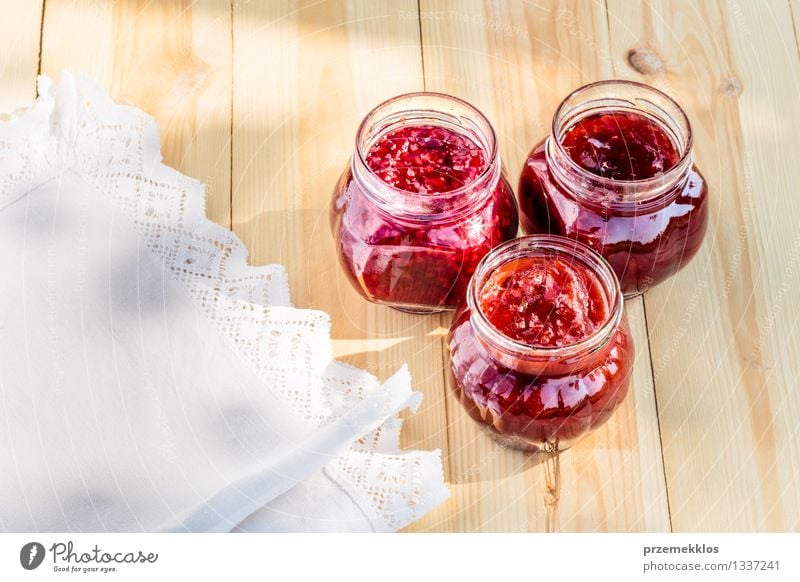 Homemade jam on wooden table Fruit Jam Breakfast Organic produce Spoon Summer Table Nature Fresh Delicious Natural Red Tradition food glass healthy Home-made