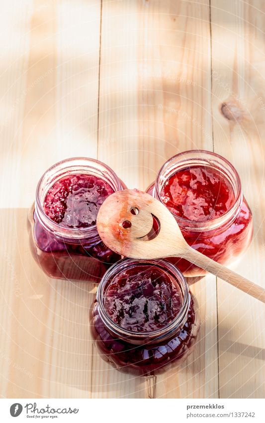Homemade jam on wooden table Fruit Jam Nutrition Breakfast Organic produce Spoon Summer Table Nature Fresh Delicious Natural Red Tradition food glass healthy