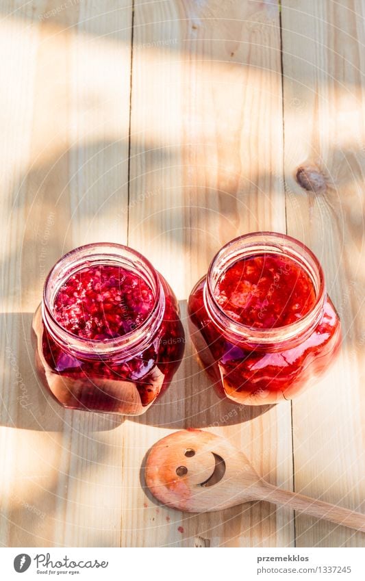 Homemade jam on wooden table Fruit Jam Nutrition Breakfast Organic produce Spoon Summer Table Nature Fresh Delicious Natural Red Tradition food glass healthy