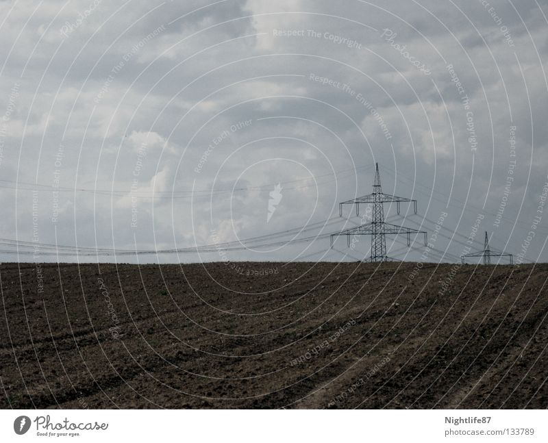 green electricity Electricity Electricity pylon Field Transmission lines Clouds Garden Bed (Horticulture) Horizon Brown Industry Boredom Sky Cable Vegetable