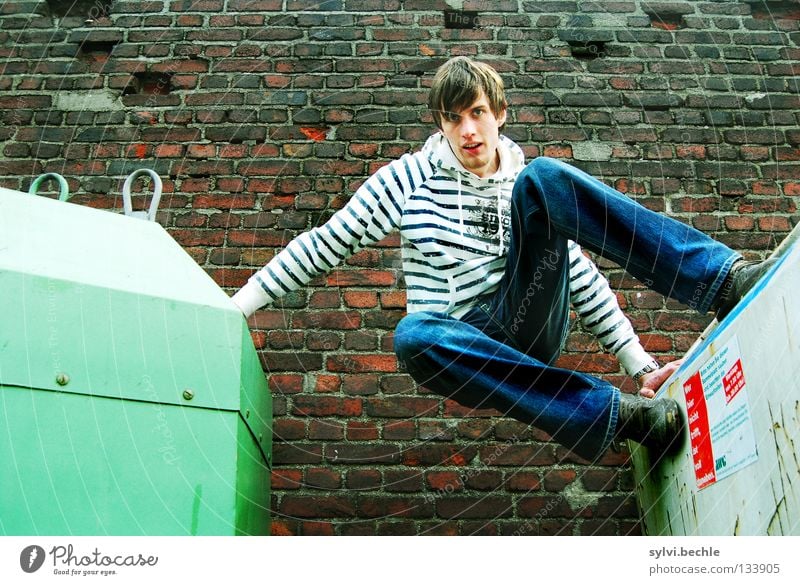 let´s go another way Beautiful Man Adults Wall (barrier) Wall (building) Jeans To hold on Jump Athletic Tall Above Green Power Striped Trash container Go up