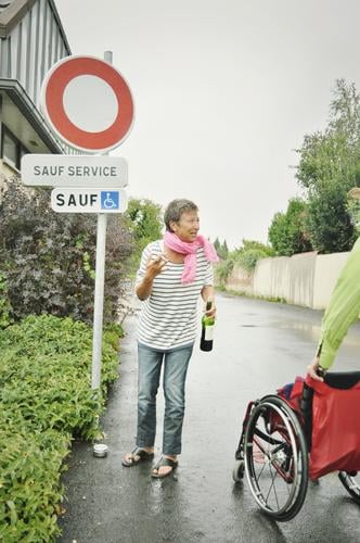 on the road again | sauf service Street Woman Wheelchair booze service French France Wordplay Alcoholic drinks bottle of wine Road sign walking impediment