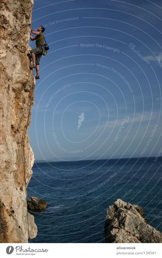 over the sea Ocean Clouds Cliff Brave Mountaineer Trust Endurance Joy Blue sky Stone Rock Climbing Power