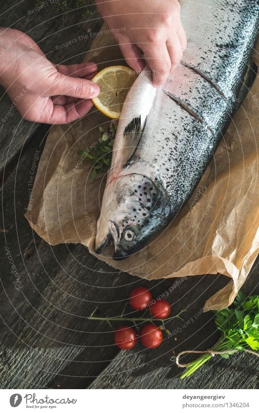 Preparing whole salmon fish for cooking. Seafood Vegetable Dinner Table Rope Paper Dark Fresh Delicious Black Cooking Raw vintage healthy mediterranean