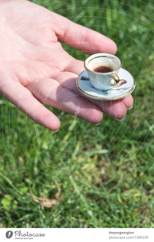 Hand hold very small cup of coffee Beverage Coffee Espresso Garden Woman Adults Arm Grass Brown Green Hold Miniature drink Café Caffeine Aromatic Close-up