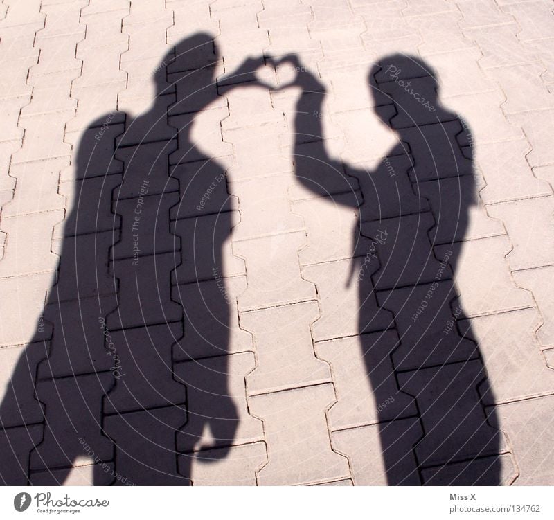 Shady sides of love Colour photo Black & white photo Exterior shot Shadow Silhouette Human being Woman Adults Friendship Hand Legs Street Stone Heart Love Gray