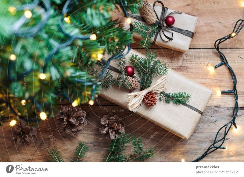 Christmas presents under a tree Tree Paper Package Box Wood Tradition Guest December Story Gift Home Horizontal Pine Rustic Seasons Wrap Colour photo