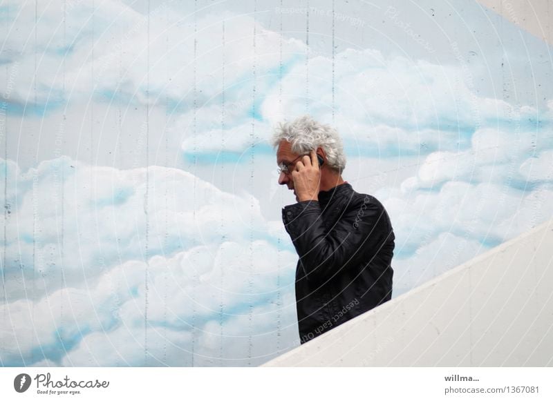 Man talking on phone on stairs in front of painted cloud wall make a phone call Telecommunications smartphone Cellphone To talk Telephone PDA Stairs