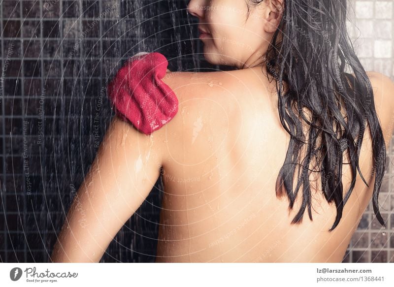 Woman using a peeling glove in a shower Lifestyle Body Skin Wellness Spa Adults Hand Gloves Hair Smiling Wet Clean Death Peeling back backside Bare bath bathing