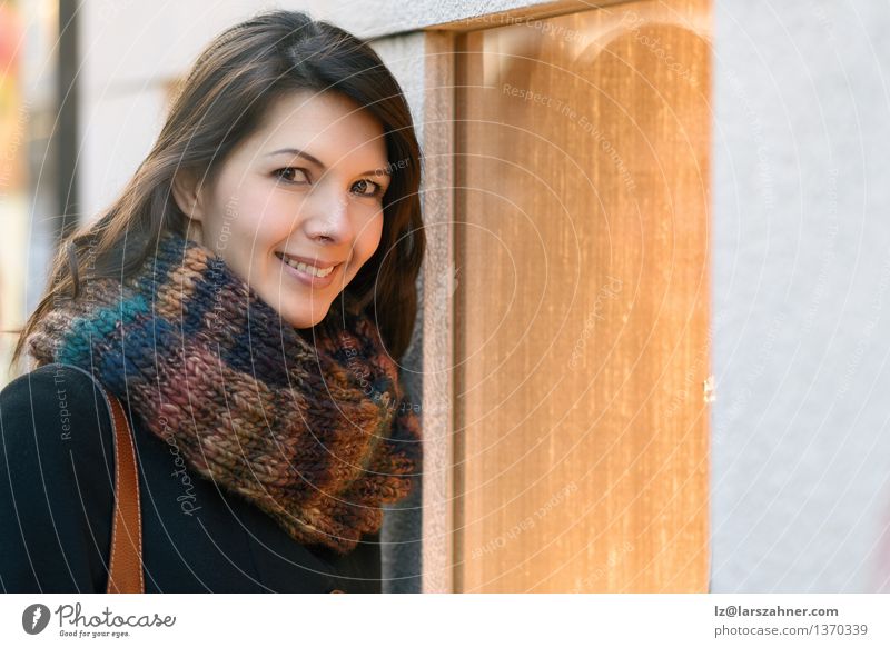 Attractive woman looking into store window Lifestyle Happy Face Winter Business Woman Adults 1 Human being 30 - 45 years Town Jewellery Scarf Brunette