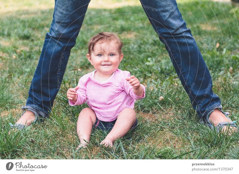 Baby sitting on a grass beside feet of mother Lifestyle Joy Happy Beautiful Child Toddler Girl Woman Adults Parents Mother Family & Relations Infancy 2