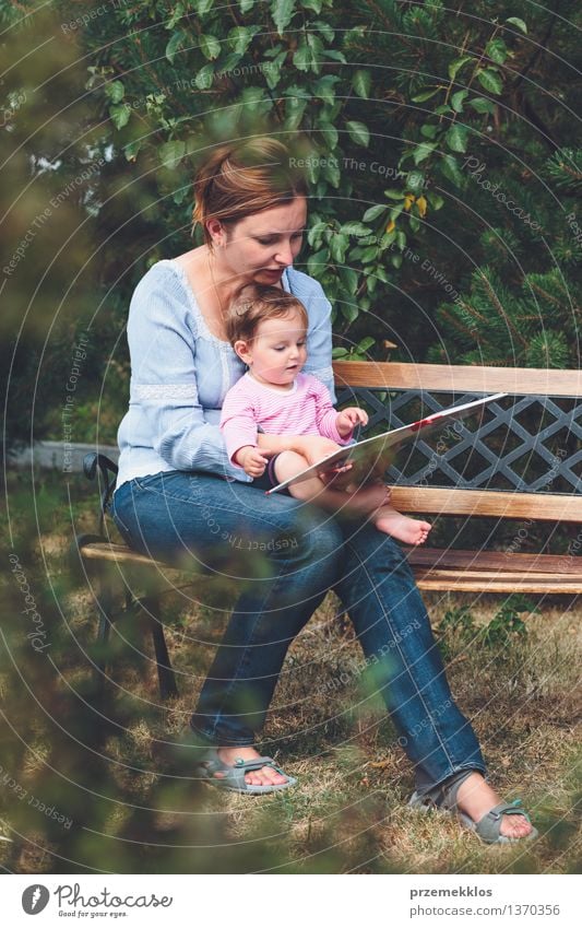 Mom reading a book her little daughter Lifestyle Joy Happy Beautiful Playing Reading Garden Child Baby Toddler Girl Woman Adults Parents Mother