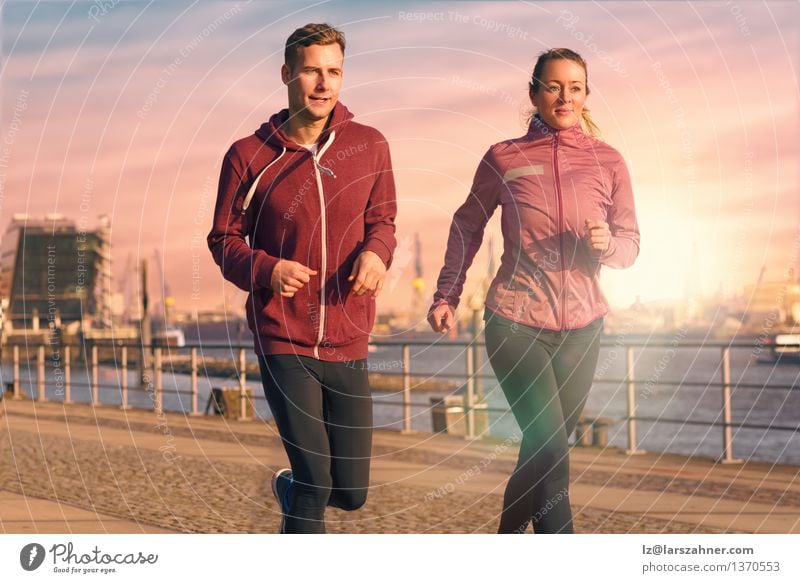 Young couple running on a seafront promenade Lifestyle Face Relaxation Sports Jogging Woman Adults Man Couple Partner 2 Human being 18 - 30 years