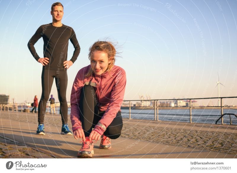 Sporty active couple on a seafront promenade Lifestyle Sports Jogging Work and employment Masculine Feminine Woman Adults Man Couple 2 Human being 18 - 30 years