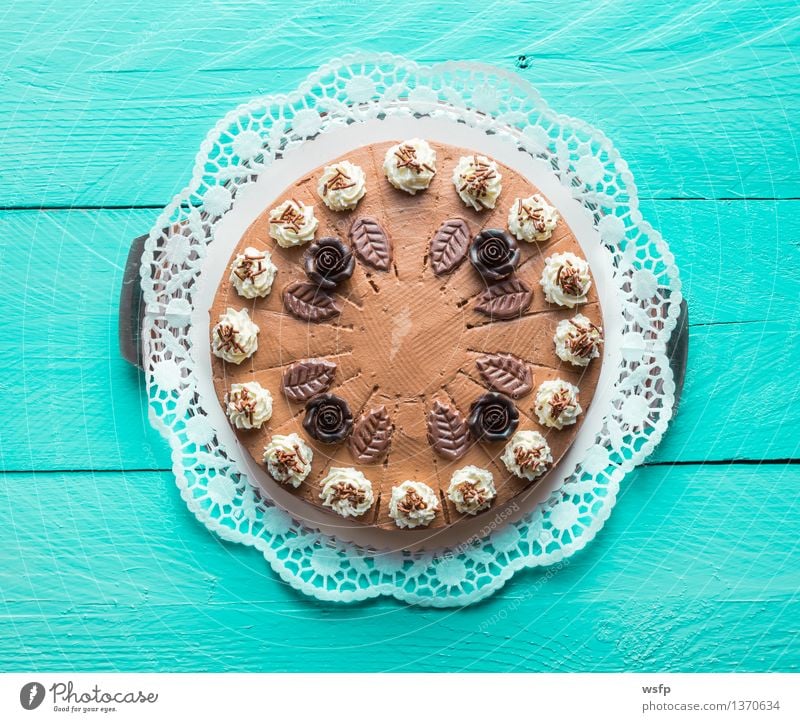 Chocolate cream cake on turquoise wood with cake lace Cake Dessert Wood Turquoise chocolate cream cake Gateau foam pastries Cream cake top Baked goods