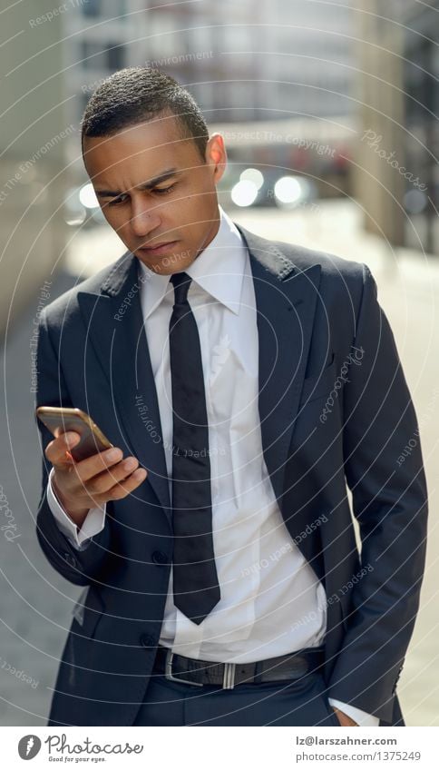 Businessman Texting on his Phone in the Street Style Reading Success Financial Industry Telephone PDA Technology Internet Man Adults Fashion Stand Modern Smart