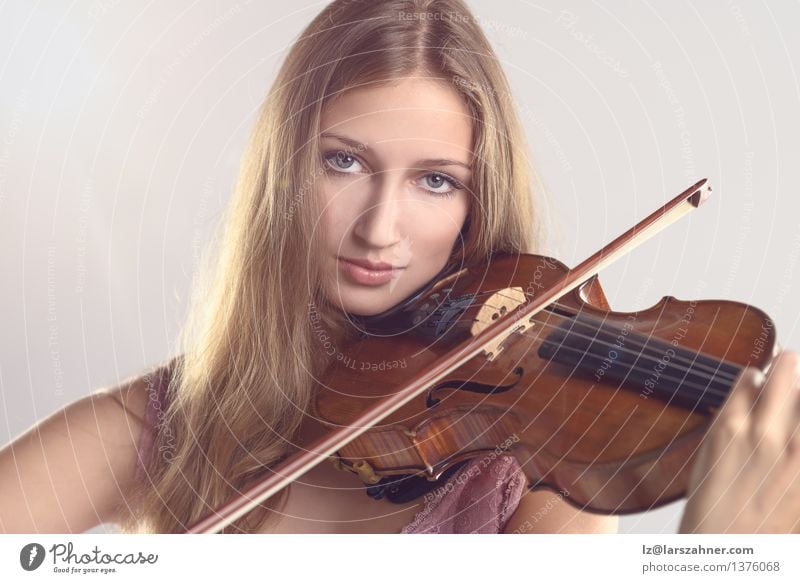 Pretty young violinist playing the violin Face Playing Music Academic studies Girl Woman Adults Youth (Young adults) Art Culture Concert Musician Violin